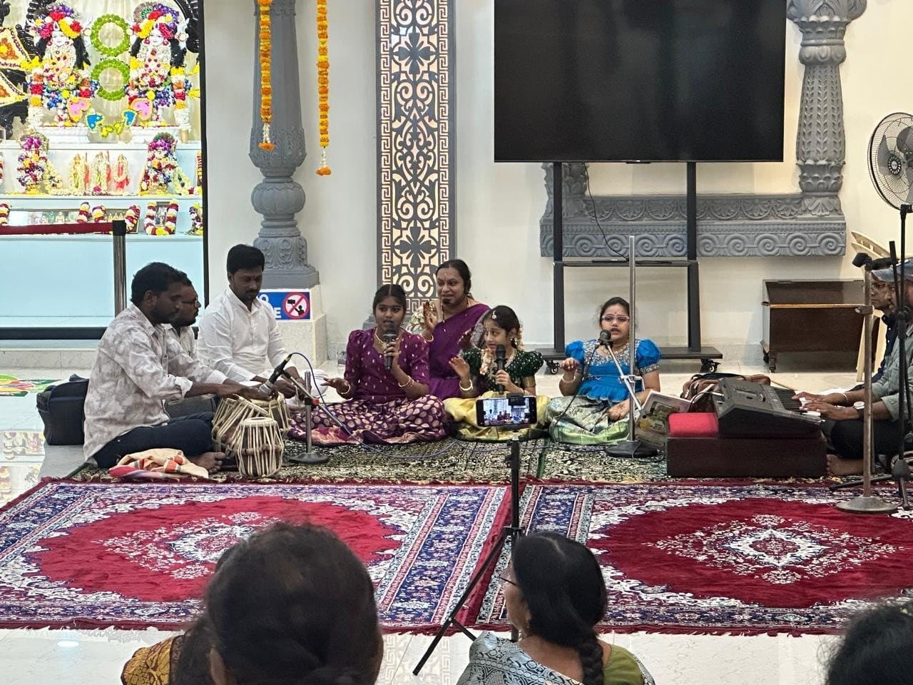Devotional singing in a decorated hall
